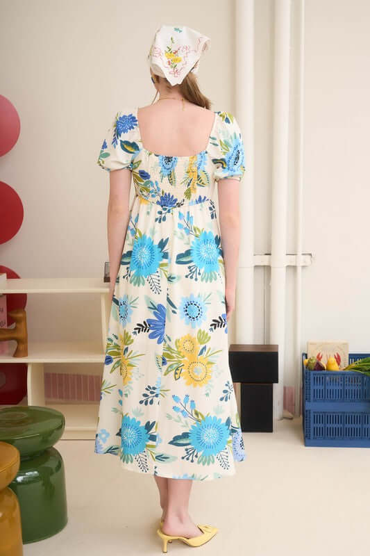 Back view of Florence Maxi Dress with square neckline, short puff sleeves, and floral print, perfect for summer outings.