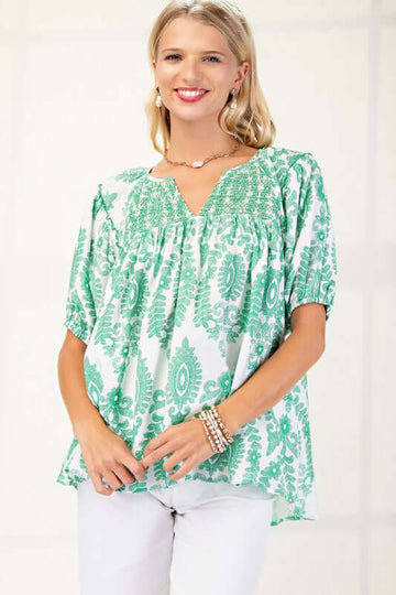 Janey Green short sleeve top with smocking, featuring a floral design, model wearing size small, perfect for a stylish summer look.