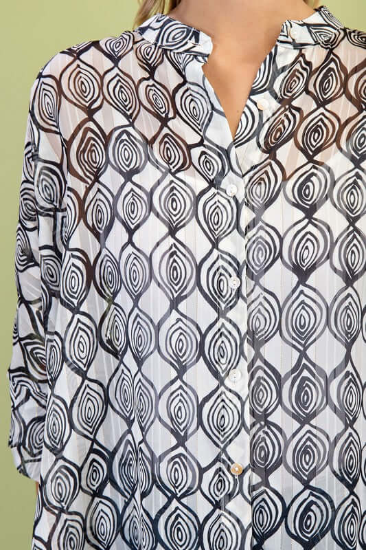Sheer lurex button-up top with a hi-low hem, featuring a bold black and white pattern, perfect for a stylish loose fit.