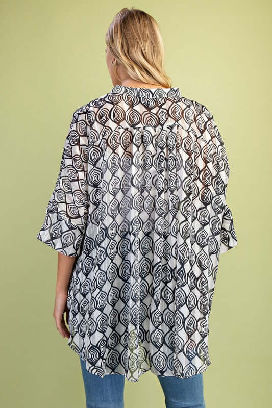 Sierra Button Up Top view from the back, featuring a loose fit, sheer lurex fabric, and hi-low hem design.