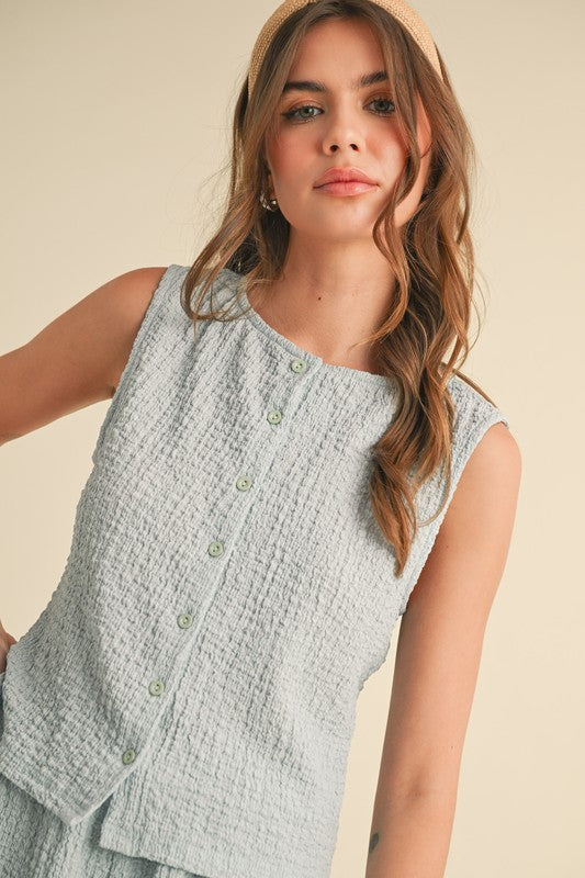 Textured knit button tank top in light blue, showcasing a stylish and comfortable summer outfit.